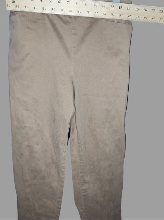 Brown pants with a ruler for scale on a dark background