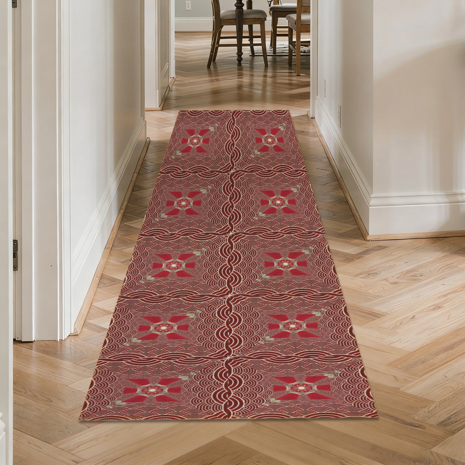 Patterned red rug on a wooden floor in a home setting