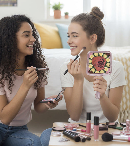 Handheld mirror with floral design on a white background