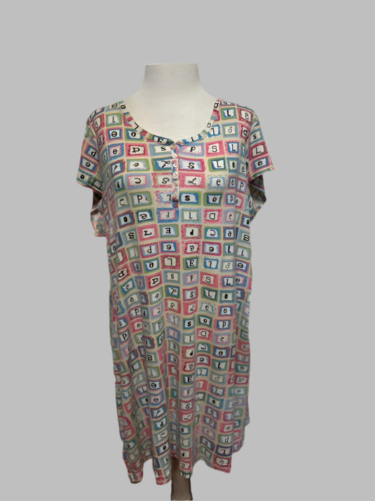 Patterned dress on a mannequin against a white door background