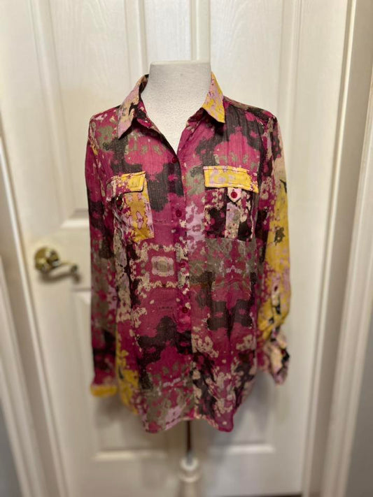 Multicolored patterned shirt on a mannequin against a white door background