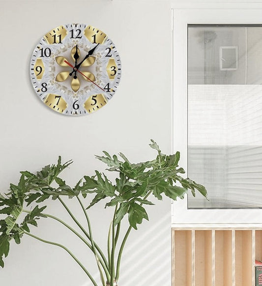 Decorative wall clock with floral design on a white wall above a potted plant in a living room.