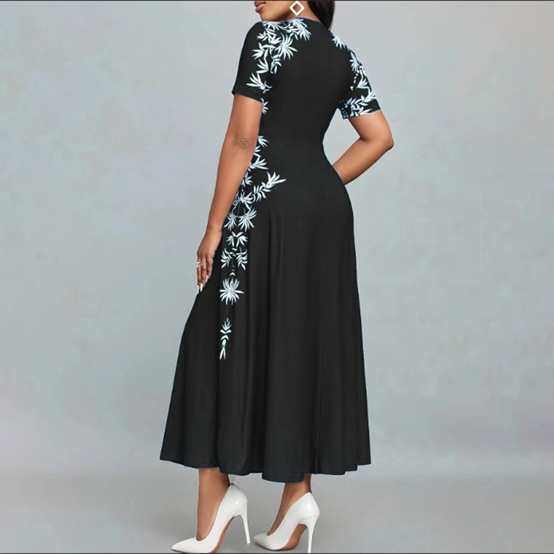 Black dress with white floral patterns on a gray background