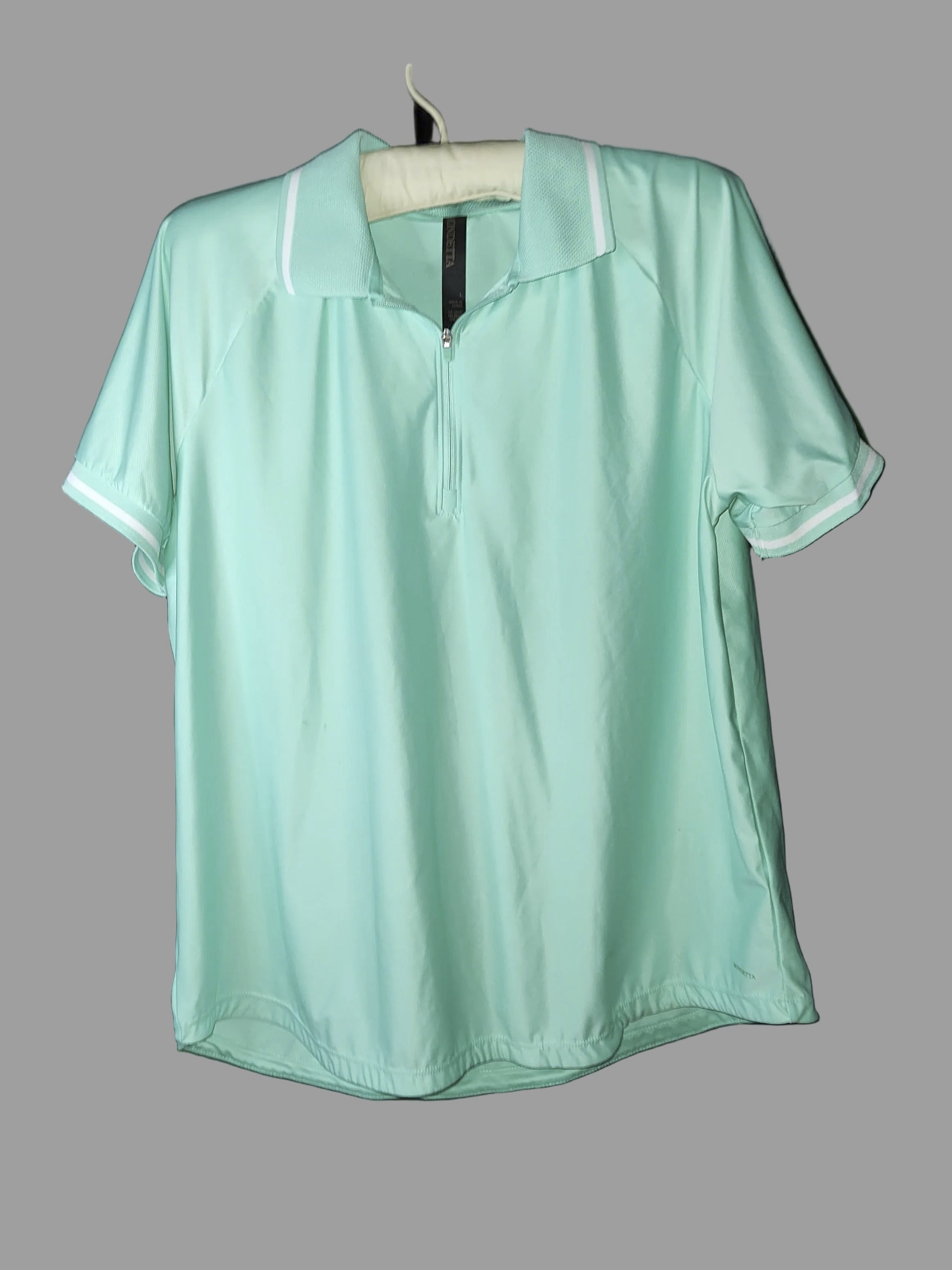 Light green shirt on a grey background