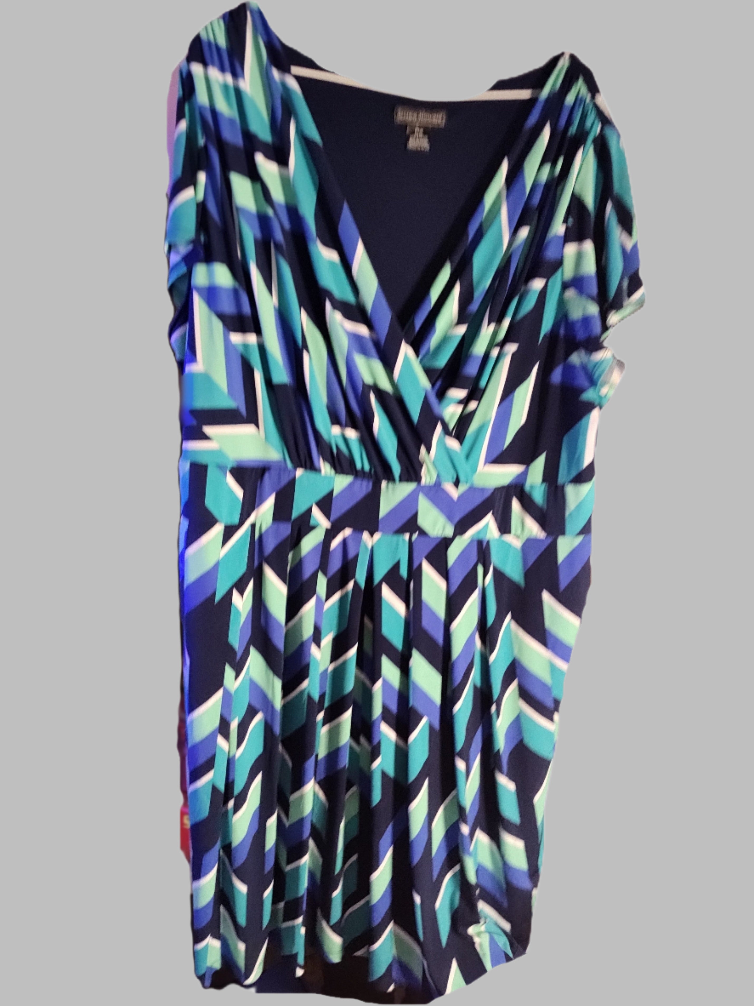 Colorful geometric patterned dress on a white background