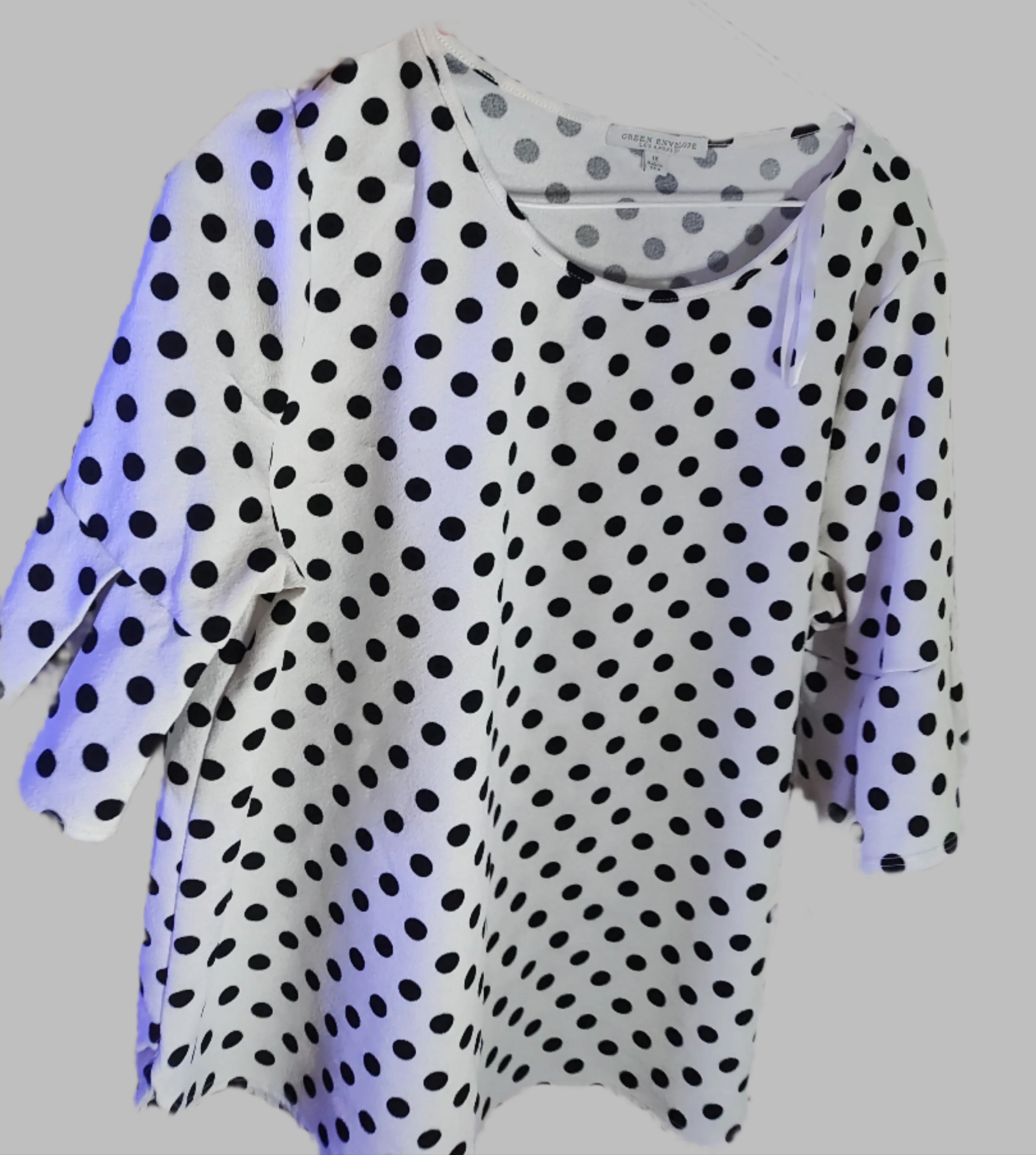 Polka dot dress on a hanger with a blurred background