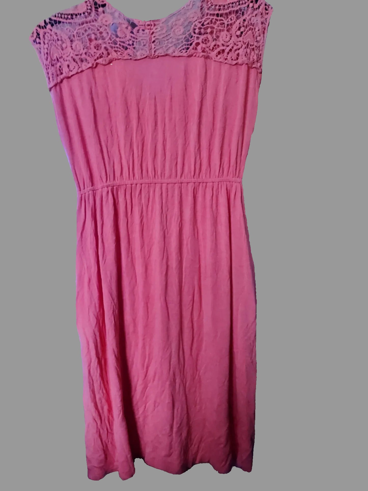 Pink dress with lace neckline on a gray background