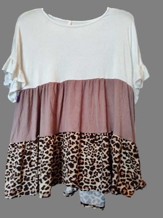Two-layered dress with white top, brown middle section, and leopard print bottom on a gray background.