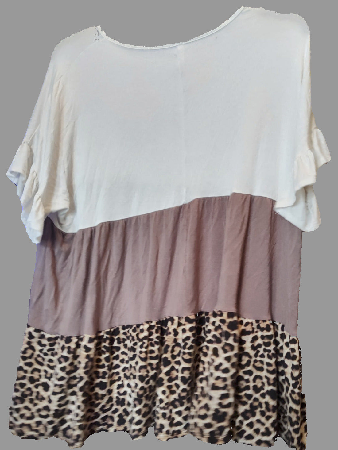 Three-layered top with white, brown, and leopard print on a gray background