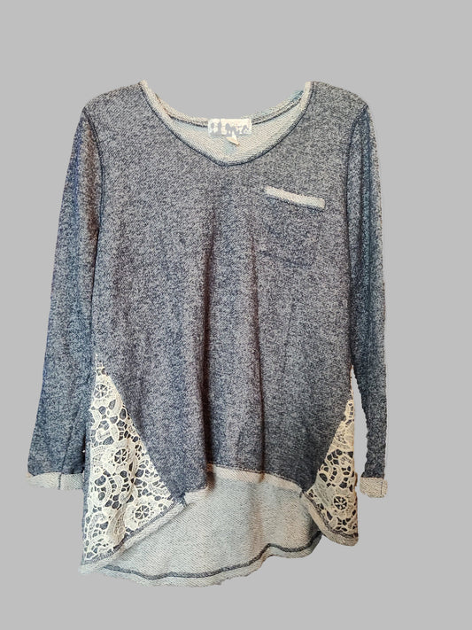 Gray long-sleeve top with lace details on a gray background