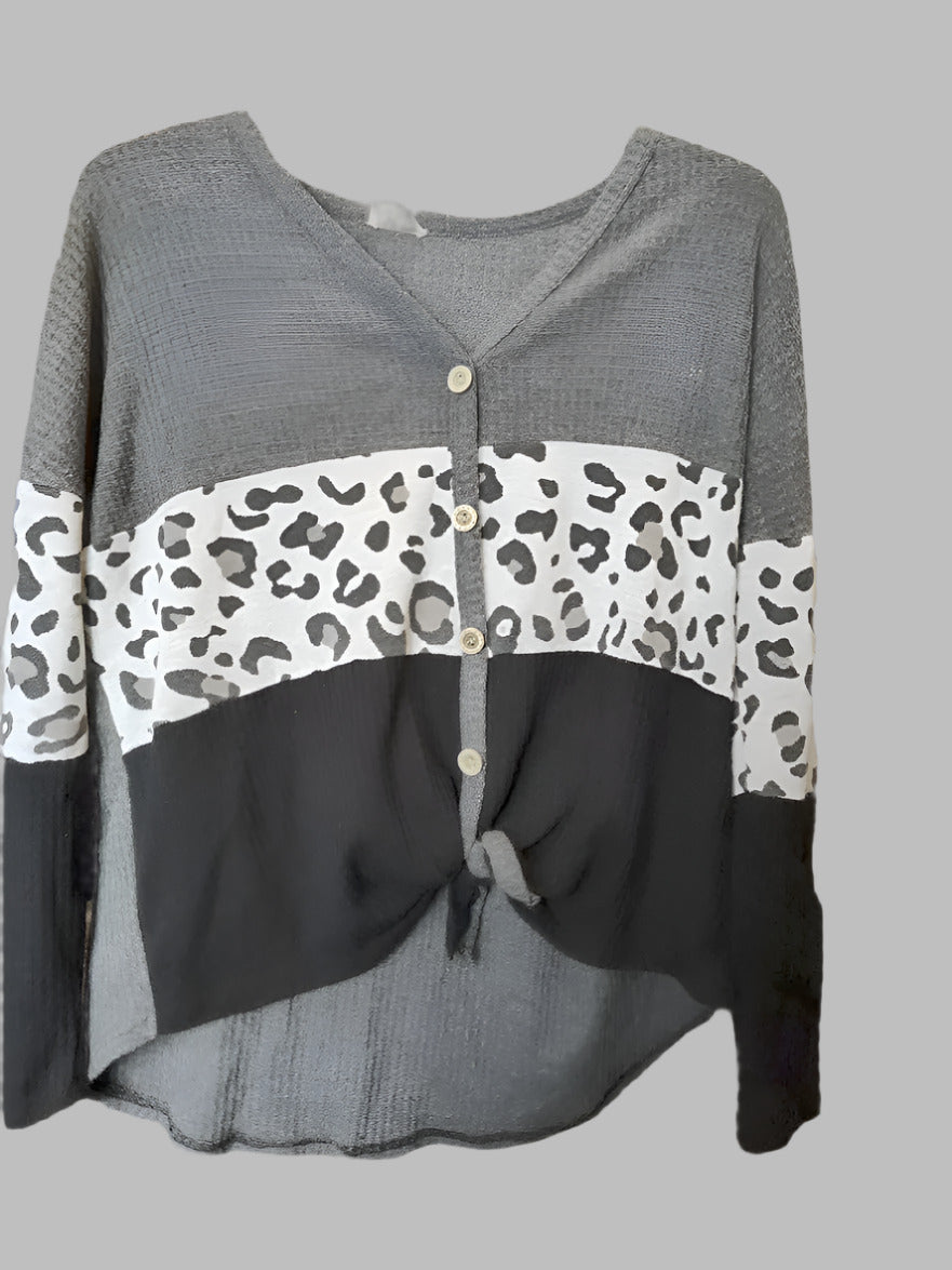Gray cardigan with leopard print accents on a gray background