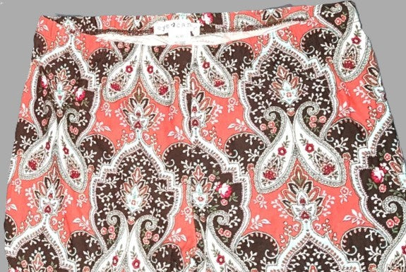 Paisley patterned shorts with a visible brand label on a gray background