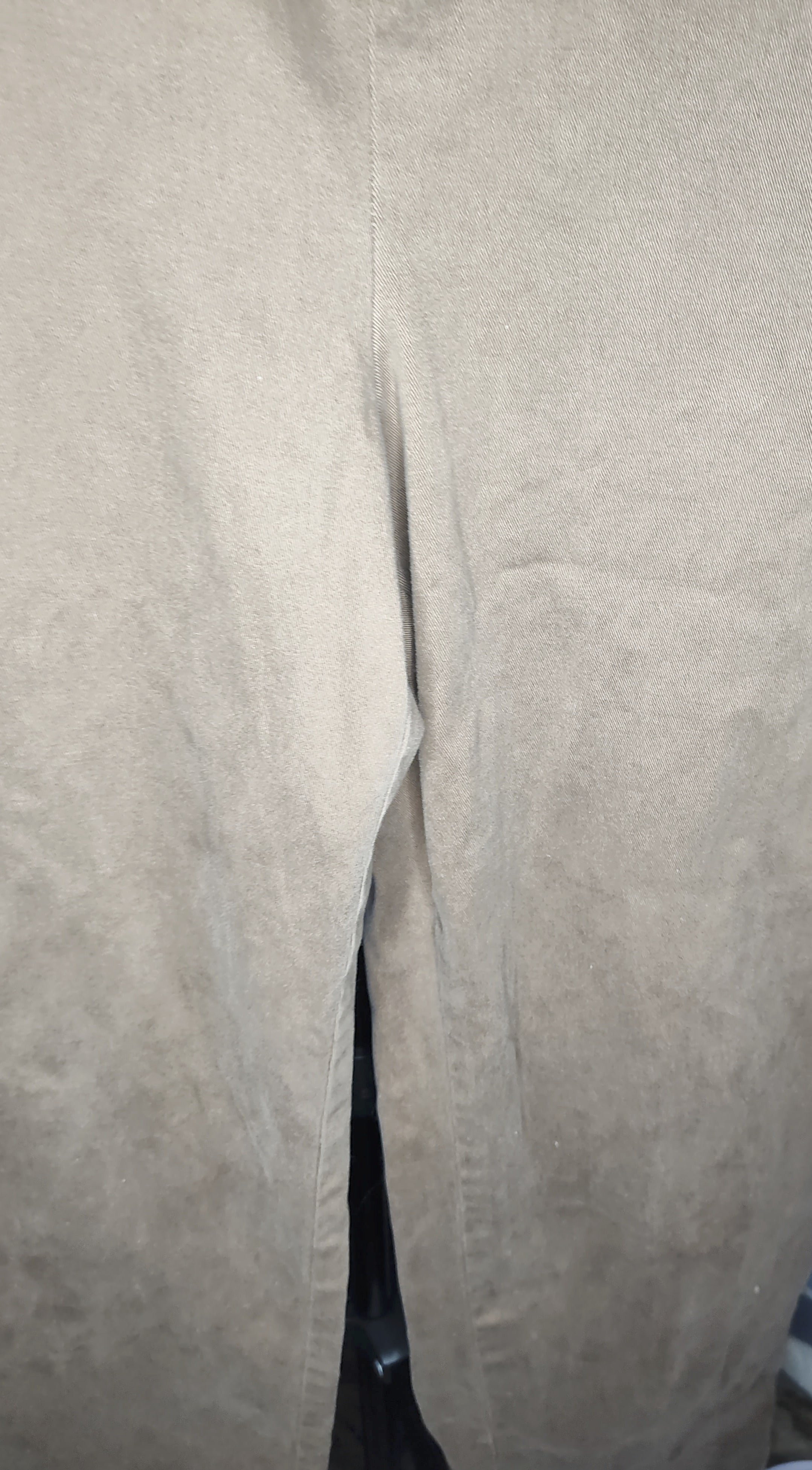 Close-up of beige pants with a blurred background