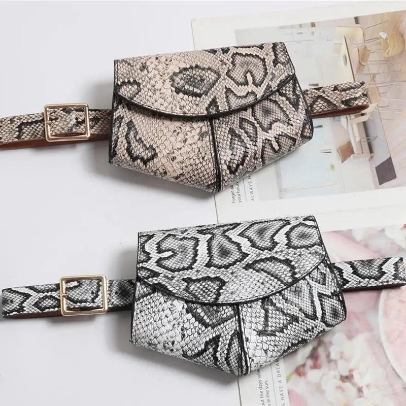 Two snake print fanny packs on a magazine background