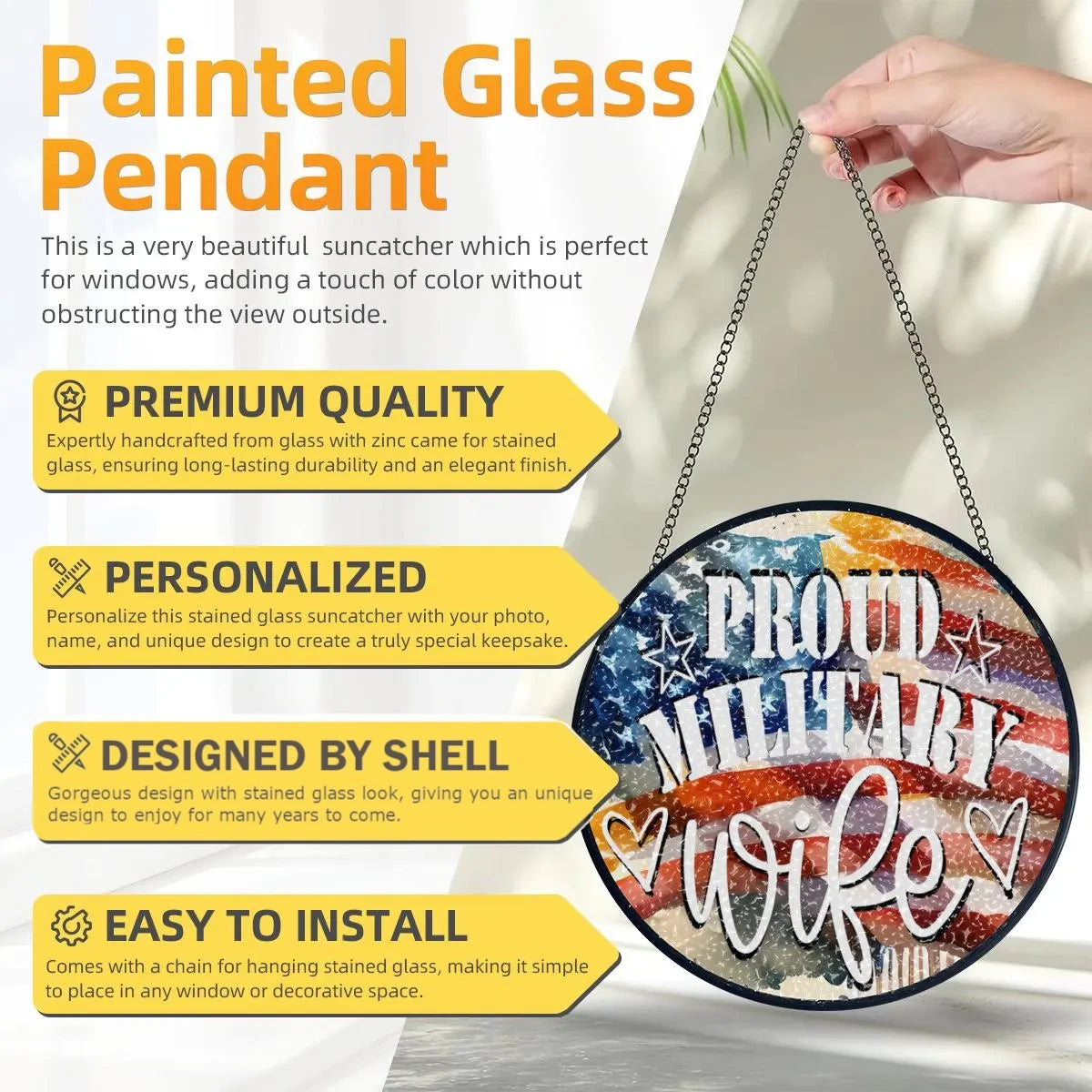 Painted glass pendant with 'Proud Military Wife' text, held by a hand against a neutral background.